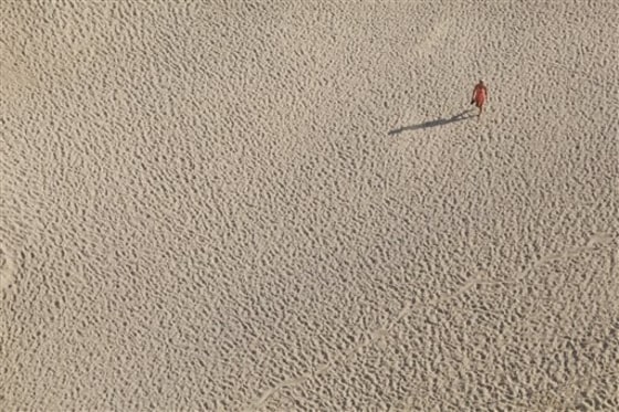 A woman walks at the Papagayo's beach in Acapulco, Mexico, on Saturday. Voters in the Pacific coast state of Guerrero, where Acapulco is located, will pick a new governor.